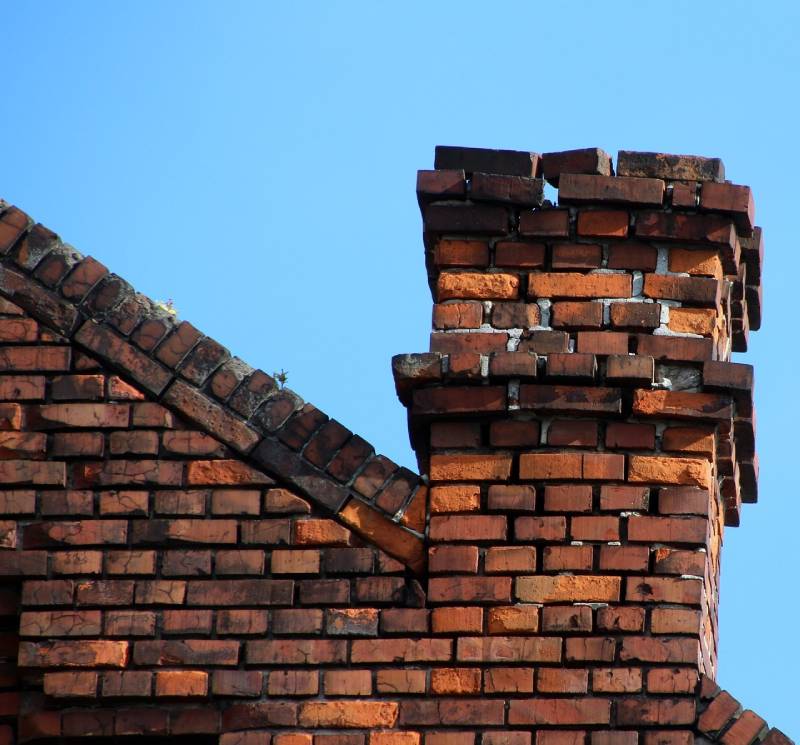 Damaged chimney on an Chatham home showing cracks and missing mortar